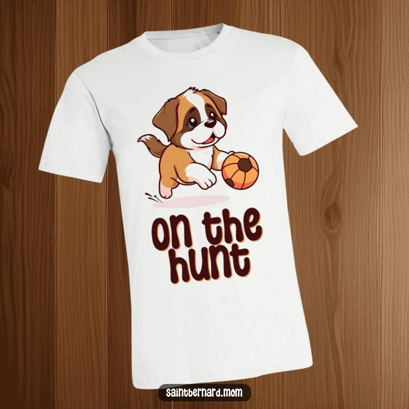 Funny Kawaii Saint Bernard t-shirt of a dog with a determined look, chasing a rolling ball, symbolizing playful focus and humorous determination.